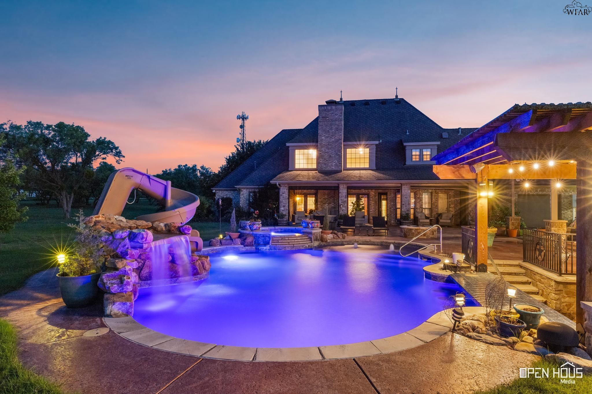 Saltwater pool with slide at dusk