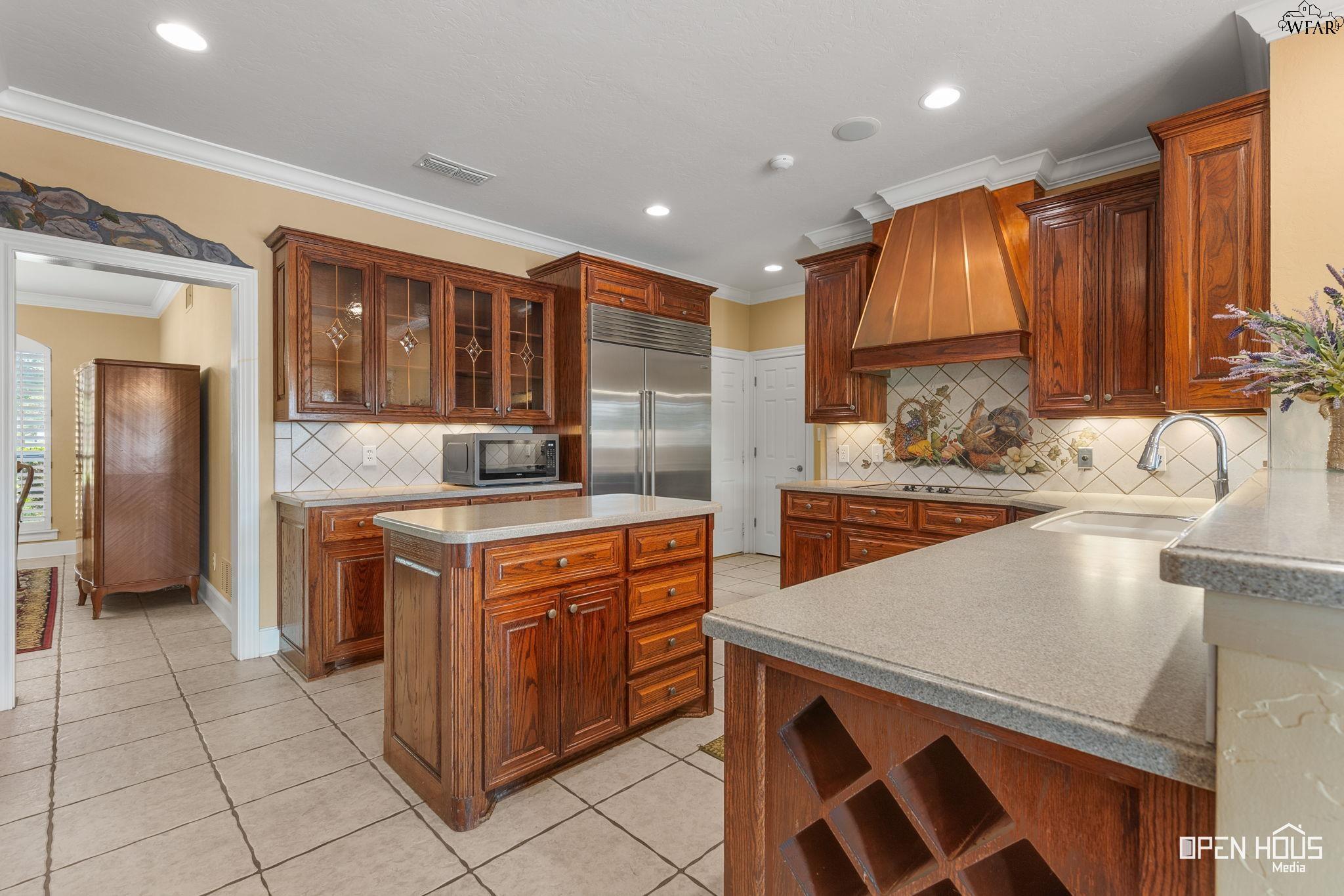 Custom kitchen with copper vent hood